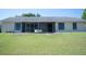 Home showcases a spacious backyard with a screened lanai at 14712 Eagles Crossing Dr, Orlando, FL 32837