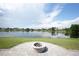 Beautiful lake view from the backyard patio featuring a cozy firepit at 14712 Eagles Crossing Dr, Orlando, FL 32837