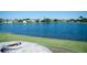 Scenic backyard view with a serene lake and inviting fire pit, perfect for outdoor relaxation and entertaining guests at 14712 Eagles Crossing Dr, Orlando, FL 32837
