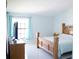 Cozy bedroom featuring a wood bed frame, a TV, neutral walls, and curtains, creating a comfortable and inviting space at 14712 Eagles Crossing Dr, Orlando, FL 32837