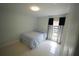Comfortable bedroom with light walls, a window, and tile flooring at 14712 Eagles Crossing Dr, Orlando, FL 32837