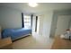 Comfortable bedroom with light walls, a window, and tile flooring at 14712 Eagles Crossing Dr, Orlando, FL 32837