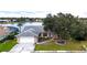 Charming single-story home with mature trees, a two-car garage, and serene lake view at 14712 Eagles Crossing Dr, Orlando, FL 32837