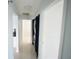 Hallway with in-unit washer and dryer hookups and tile flooring at 14712 Eagles Crossing Dr, Orlando, FL 32837