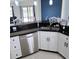 Renovated kitchen boasts stainless steel appliances, granite countertops, and ample storage at 14712 Eagles Crossing Dr, Orlando, FL 32837