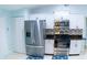 Well-equipped kitchen with stainless steel appliances and white cabinetry at 14712 Eagles Crossing Dr, Orlando, FL 32837