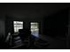 Dim living room with modern furniture and a tranquil lake view through sliding glass doors at 14712 Eagles Crossing Dr, Orlando, FL 32837