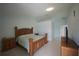 Spacious main bedroom featuring wood furniture, light walls, and tile floors at 14712 Eagles Crossing Dr, Orlando, FL 32837