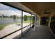 Enclosed patio space with views of a beautiful lake and a cozy firepit area at 14712 Eagles Crossing Dr, Orlando, FL 32837