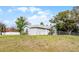 View of the fenced backyard and the exterior of the single-story home with light gray siding at 1499 Courtland Blvd, Deltona, FL 32738