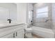 Modern bathroom features gray marble style tiling, shower-tub combo, and vanity at 15354 Sw 43Rd Avenue Rd, Ocala, FL 34473