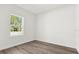 Well-lit bedroom with wood-look floors and a window offering a pleasant outdoor view at 15354 Sw 43Rd Avenue Rd, Ocala, FL 34473