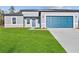 Charming single-Gathering home with a well-manicured lawn and a stylish blue garage door at 15354 Sw 43Rd Avenue Rd, Ocala, FL 34473