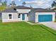 Charming single-Gathering home with a well-manicured lawn and a stylish blue garage door at 15354 Sw 43Rd Avenue Rd, Ocala, FL 34473