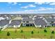 Backyard of the home from an aerial view in a neighborhood featuring well-maintained lawns at 17052 Cercis Loop, Clermont, FL 34711