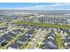 An aerial view showcases a modern neighborhood, revealing consistent architecture and landscaped surroundings at 17052 Cercis Loop, Clermont, FL 34711