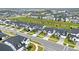 An aerial view of a modern residential community featuring well-manicured lawns and uniform home designs at 17052 Cercis Loop, Clermont, FL 34711