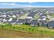 Panoramic aerial shot of a suburban community with well-kept lawns and tree-lined streets at 17052 Cercis Loop, Clermont, FL 34711