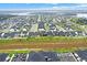 Birds eye shot of a residential area highlighting the uniformity of houses and community layout near a lake at 17052 Cercis Loop, Clermont, FL 34711