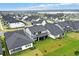 Wide aerial view of a residential neighborhood surrounded by green landscapes at 17052 Cercis Loop, Clermont, FL 34711
