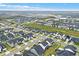 A high-angle view presents a housing development, with matching homes neatly arranged on landscaped lots at 17052 Cercis Loop, Clermont, FL 34711