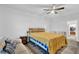 Bedroom features a bed, couch, and chairs and modern flooring near an entranceway at 17052 Cercis Loop, Clermont, FL 34711