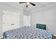 Bright bedroom with wood-look flooring, ceiling fan and white trim at 17052 Cercis Loop, Clermont, FL 34711