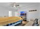 Bright bedroom featuring a ceiling fan, TV, and comfortable seating area at 17052 Cercis Loop, Clermont, FL 34711