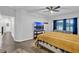 Bright bedroom featuring a ceiling fan, TV, and comfortable seating area at 17052 Cercis Loop, Clermont, FL 34711