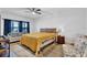 Bedroom features a bed, couch, and chairs and modern flooring with great natural light at 17052 Cercis Loop, Clermont, FL 34711