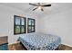 Cozy bedroom with wood-look flooring, plantation shutters and a ceiling fan at 17052 Cercis Loop, Clermont, FL 34711