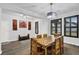 Bright dining room features modern light fixture, brown window shutters and a unique wooden table set at 17052 Cercis Loop, Clermont, FL 34711