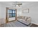 Cozy hallway sitting area featuring a sofa, decorative rug, and bright natural light at 17052 Cercis Loop, Clermont, FL 34711