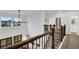 Second story hallway overlooks the living space and features modern railing and windows at 17052 Cercis Loop, Clermont, FL 34711