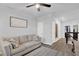Comfortable hallway sitting area featuring a sofa, decorative rug and bright natural light at 17052 Cercis Loop, Clermont, FL 34711
