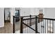 Second story hallway features modern railing and access to the bedrooms and bathrooms at 17052 Cercis Loop, Clermont, FL 34711