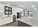 Bright kitchen features modern appliances, white cabinets, quartz countertops and stainless steel sink at 17052 Cercis Loop, Clermont, FL 34711