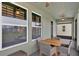 A charming screened patio with an outdoor dining area and serene neighborhood views at 17052 Cercis Loop, Clermont, FL 34711
