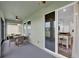 View of the patio, connected to the interior by a sliding glass door, with a glimpse of the kitchen at 17052 Cercis Loop, Clermont, FL 34711