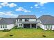 Aerial view of the home's backyard, screened patio, landscaping, and neighboring properties at 17052 Cercis Loop, Clermont, FL 34711