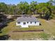 Aerial view of the home, showcasing the yard and the surrounding trees at 1870 Blackwelder Rd, De Leon Springs, FL 32130
