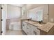 Bathroom with double sink vanity, granite countertops, large mirror, and a tub at 1870 Blackwelder Rd, De Leon Springs, FL 32130