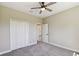Bedroom features neutral walls, carpet floors, a ceiling fan and a closet at 1870 Blackwelder Rd, De Leon Springs, FL 32130