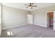Neutral bedroom with carpet, ceiling fan, and views into the closet and other rooms at 1870 Blackwelder Rd, De Leon Springs, FL 32130