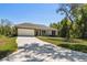 Lovely single-story home featuring a two-car garage, stone accents, and a long driveway at 1870 Blackwelder Rd, De Leon Springs, FL 32130