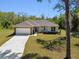 Lovely single-story home with a two-car garage, stone accents, and a well-maintained lawn at 1870 Blackwelder Rd, De Leon Springs, FL 32130
