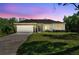 Charming single-story home featuring a two-car garage, stone accents, and a well-manicured lawn at 1870 Blackwelder Rd, De Leon Springs, FL 32130