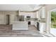 Modern kitchen featuring white cabinets, stainless steel appliances, granite countertops, and a center island at 1870 Blackwelder Rd, De Leon Springs, FL 32130