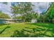 Large backyard with a shed and mature trees on a sunny day at 217 Wilmer Ave, Orlando, FL 32811