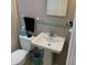 Bathroom with a pedestal sink, mirrored wall, and a black towel at 217 Wilmer Ave, Orlando, FL 32811